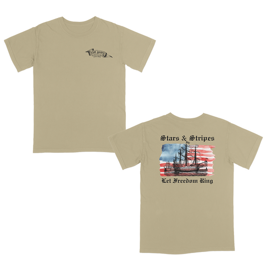 Khaki patriotic graphic tee featuring a vintage sailing ship over an American flag with “Stars & Stripes” and “Let Freedom Ring” artwork celebrating 250 years of American freedom and heritage.