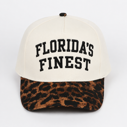 Florida’s Finest embroidered snapback hat featuring bold black lettering, cream crown, leopard print curved brim, structured fit, and stylish Florida-inspired casual design.