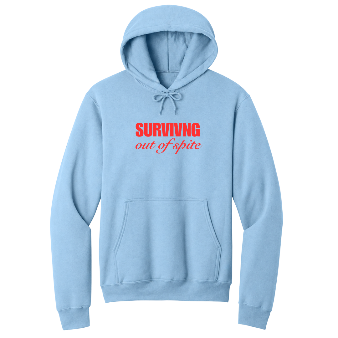 Front view of a light blue pullover hoodie featuring the phrase "SURVIVING" in bold red block letters above the words "out of spite" in elegant red script centered on the chest. The minimalist motivational graphic contrasts sharply against the black fabric, creating a clean, modern hoodie with a witty and resilient statement design.