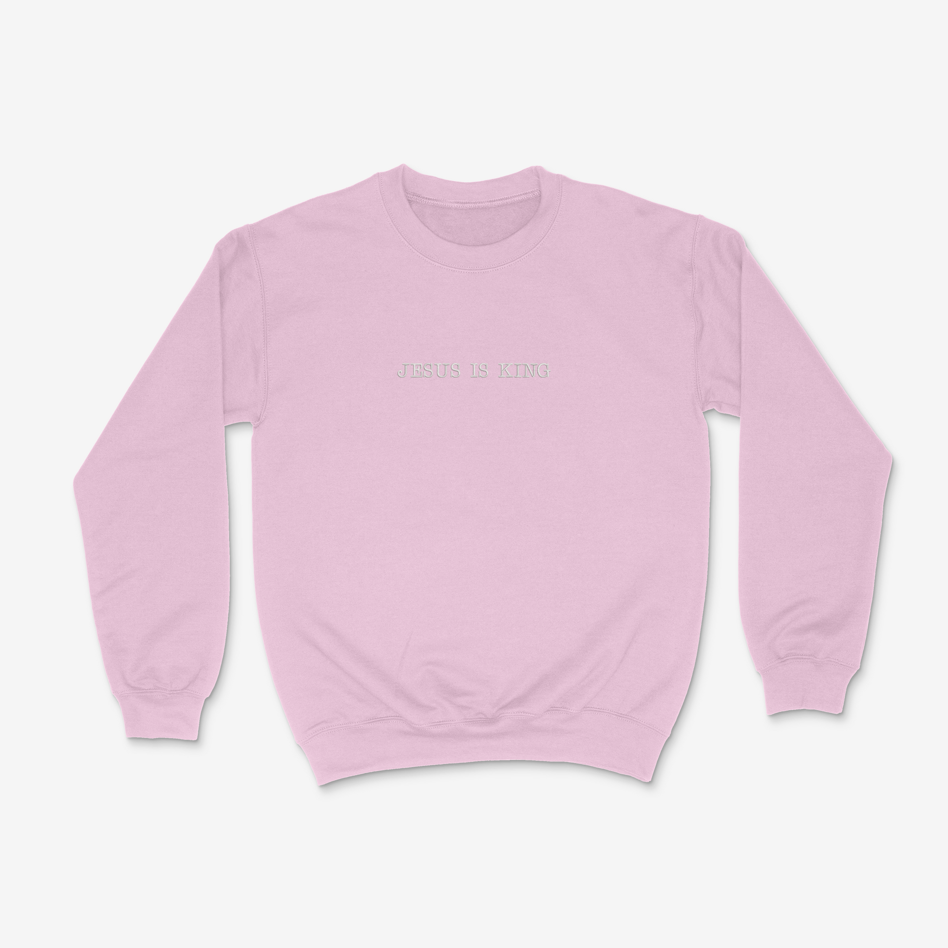 Light pink sweatshirt with 'Jesus is King' text on a white background