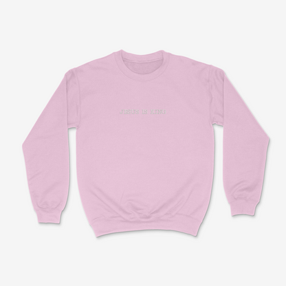 Light pink sweatshirt with 'Jesus is King' text on a white background