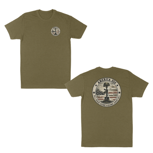Military green patriotic memorial t-shirt featuring a small front chest badge and large back graphic with battlefield cross memorial, distressed American flag, “America 250” design, and “All Gave Some • Some Gave All” tribute text.