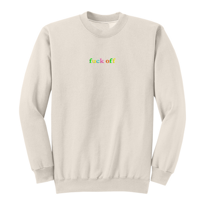 Front view of a natural long sleeve crewneck featuring the phrase "fuck off" in small lowercase letters centered across the chest. Each letter is embroidered in a different bright color, creating a subtle rainbow-inspired design with a clean, minimalist aesthetic. A bold adult long sleeve shirt with colorful typography, casual streetwear style, and sarcastic humor.
