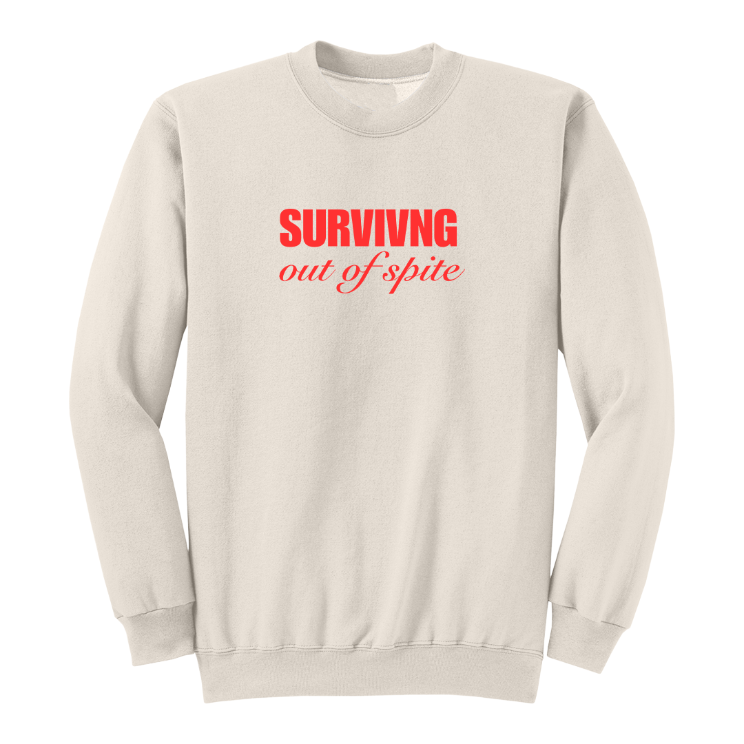 Front view of a natural crewneck sweatshirt featuring the phrase "SURVIVING" in bold red block letters above the words "out of spite" in elegant red script centered on the chest. The clean, minimalist design stands out against the black fabric, creating a bold statement sweatshirt with a resilient and motivational aesthetic.