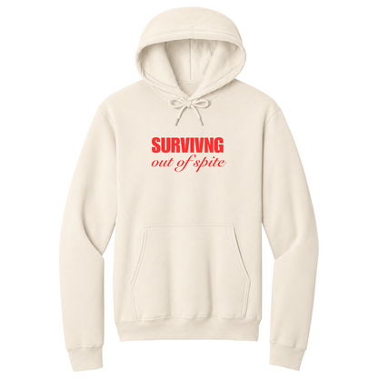 Front view of a natural pullover hoodie featuring the phrase "SURVIVING" in bold red block letters above the words "out of spite" in elegant red script centered on the chest. The minimalist motivational graphic contrasts sharply against the black fabric, creating a clean, modern hoodie with a witty and resilient statement design.