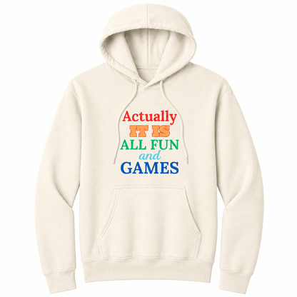 Front view of a natural pullover hoodie featuring the phrase "Actually IT IS ALL FUN and GAMES" in stacked multicolored typography. "Actually" is red, "IT IS" is gold with a red outline, "ALL FUN" is green, "and" is written in light blue script, and "GAMES" is bold blue. The drawstrings naturally drape over the design, creating a realistic product mockup. This colorful retro-inspired graphic hoodie is perfect for casual wear, game nights, parties, and anyone with a playful sense of humor.