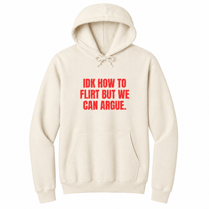 Front view of a natural pullover hoodie featuring the bold red statement "IDK HOW TO FLIRT BUT WE CAN ARGUE." centered on the chest in large uppercase block lettering. The drawstrings are tied into a short bow above the design, creating a realistic product mockup. A funny sarcastic hoodie for adults with relationship humor, bold typography, and casual streetwear style.