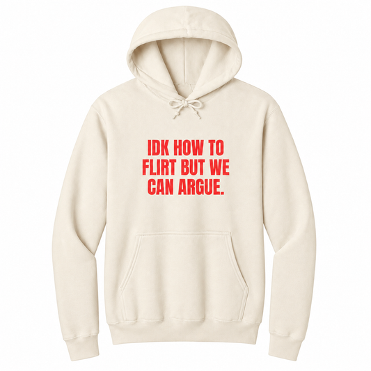 Front view of a natural pullover hoodie featuring the bold red statement "IDK HOW TO FLIRT BUT WE CAN ARGUE." centered on the chest in large uppercase block lettering. The drawstrings are tied into a short bow above the design, creating a realistic product mockup. A funny sarcastic hoodie for adults with relationship humor, bold typography, and casual streetwear style.