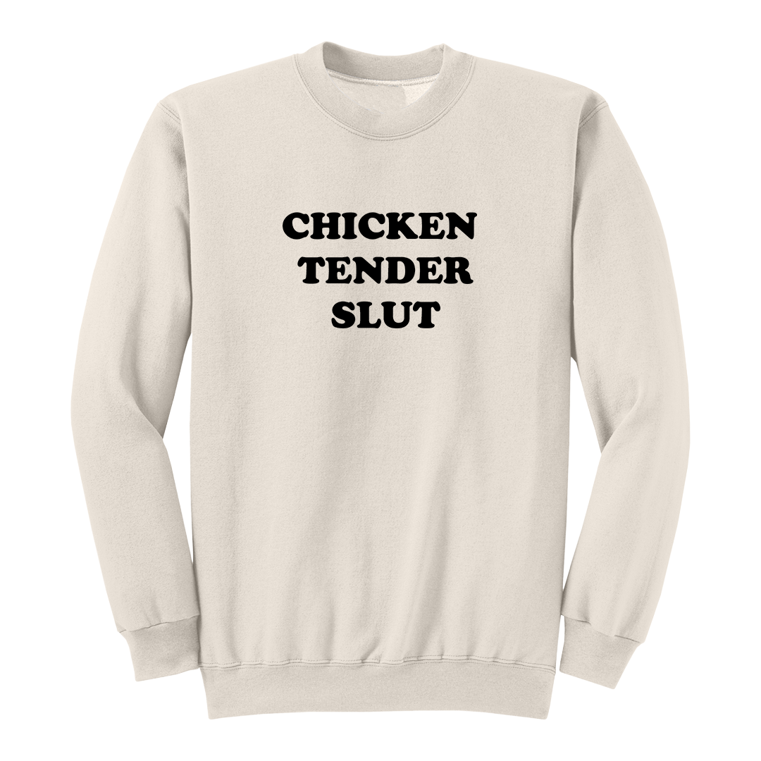 Front view of a natural crewneck sweatshirt featuring the bold black stacked phrase "CHICKEN TENDER SLUT" in large retro bubble lettering centered on the chest. The simple vintage-inspired typography stands out against the black fabric, creating a humorous foodie-themed graphic sweatshirt with a clean, minimalist, and playful design.