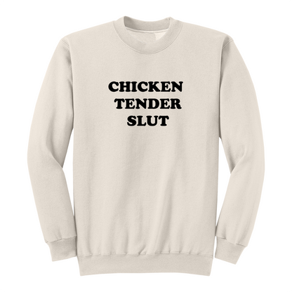 Front view of a natural crewneck sweatshirt featuring the bold black stacked phrase "CHICKEN TENDER SLUT" in large retro bubble lettering centered on the chest. The simple vintage-inspired typography stands out against the black fabric, creating a humorous foodie-themed graphic sweatshirt with a clean, minimalist, and playful design.