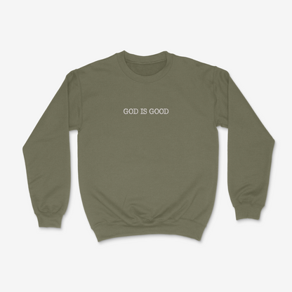 Olive drab sweatshirt with 'GOD IS GOOD' text on a white background