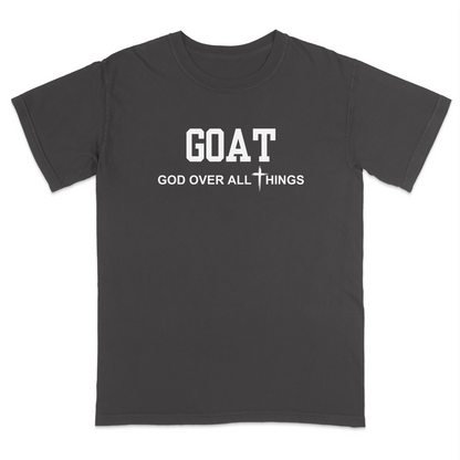 Dark Grey faith-based Christian t-shirt featuring the bold word “GOAT” across the chest with the phrase “God Over All Things” underneath and a white cross graphic. Inspirational religious apparel designed for believers, church events, youth groups, Christian streetwear, Bible study gatherings, and everyday faith-centered fashion.