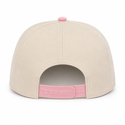 Back view of a cream snapback hat featuring a pink top button and an adjustable pink snapback closure. Displayed on a white background, showcasing the clean rear design and structured fit.