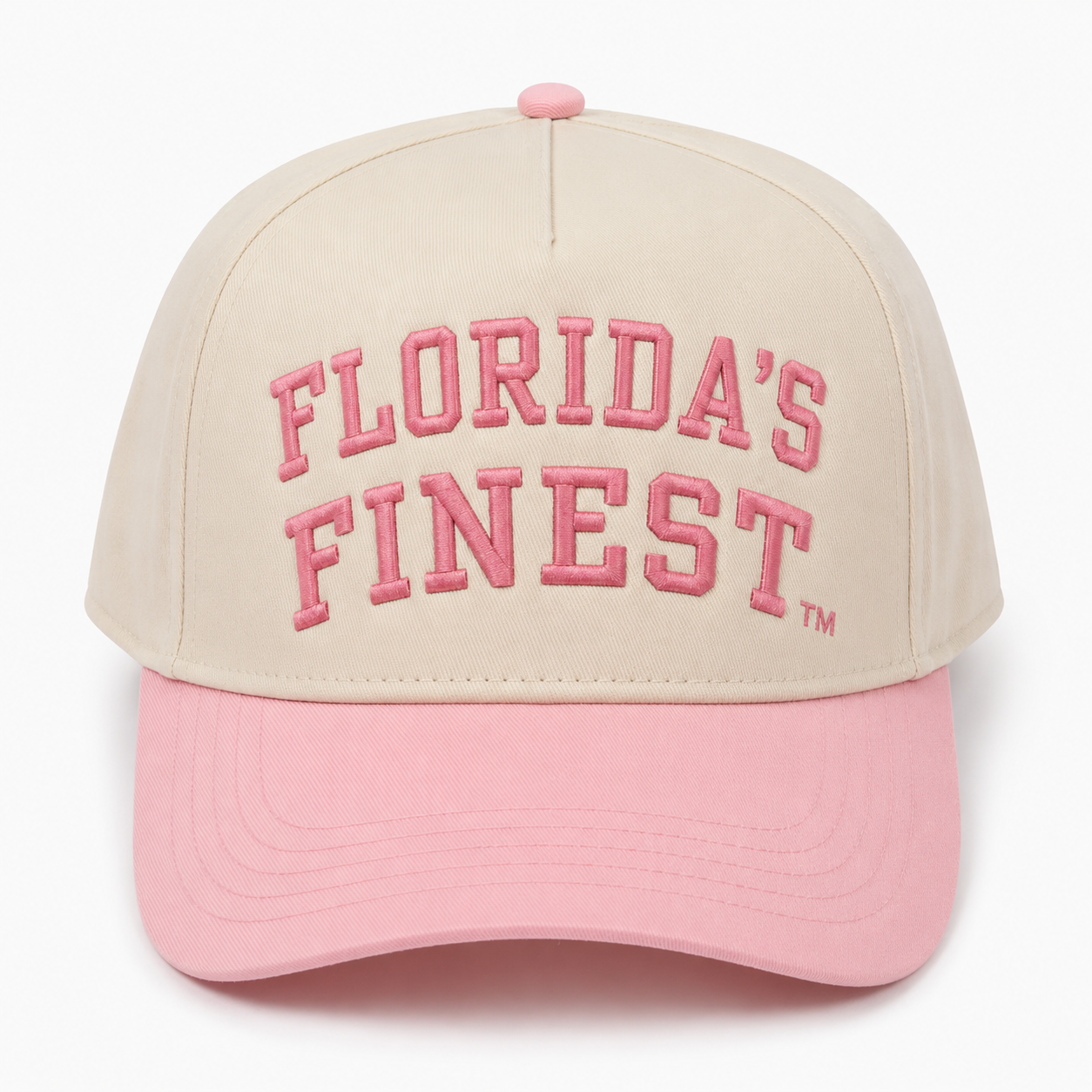 Front view of a cream snapback hat featuring raised pink "Florida's Finest" embroidery with a matching TM symbol and a pastel pink curved bill. Displayed on a white background, highlighting the soft two-tone design and premium embroidered details.