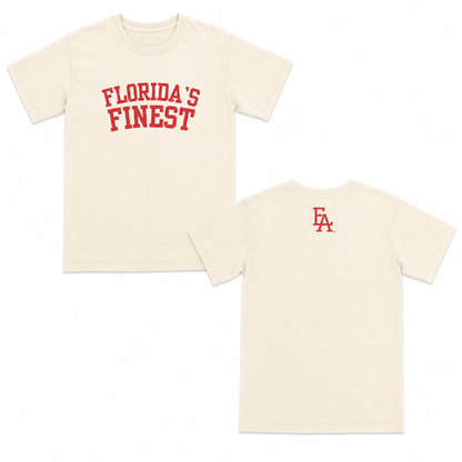 Cream short-sleeve T-shirt featuring bold red “Florida’s Finest” text on the front and a minimalist green “FLA” logo centered on the upper back.
