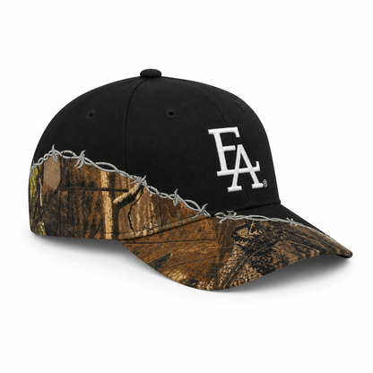Side profile view of a black snapback hat featuring a white embroidered FLA®-style logo, Realtree-inspired camo brim and side panels, and silver barbed wire embroidery for a rugged outdoor streetwear aesthetic.
