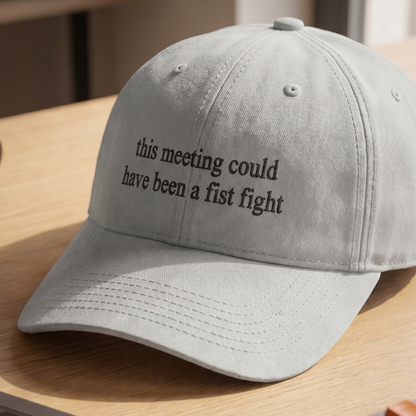 Light gray embroidered dad hat featuring the phrase “this meeting could have been a fist fight” in black lettering. Funny office humor cap with a minimalist design, perfect for coworkers, managers, workplace gifts, and casual everyday wear.