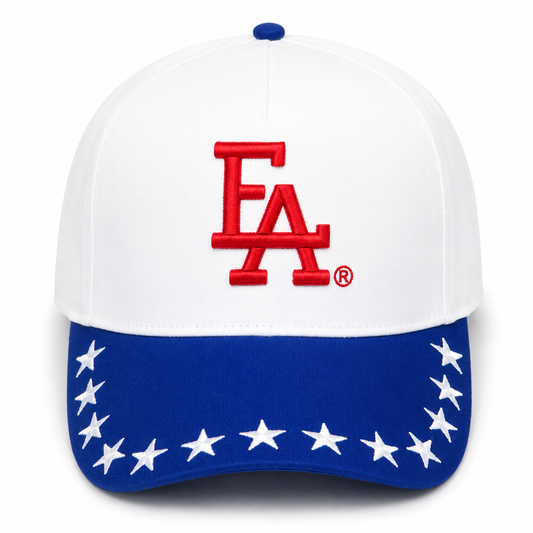 White and royal blue patriotic snapback hat featuring a bold red FLA® embroidered logo, blue brim with white embroidered stars, and a clean Americana-inspired design.