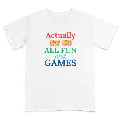 Front white of a black graphic T-shirt featuring the phrase "Actually It Is All Fun and Games" in bold multicolored lettering, with "Actually" in red, "IT IS" in gold, "ALL FUN" in green, "and" in light blue script, and "GAMES" in blue. This colorful humorous graphic tee has a playful retro-inspired design, making it perfect for casual wear, parties, game nights, and everyday outfits.