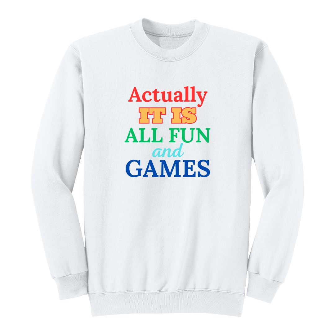 Front view of a white long sleeve graphic T-shirt featuring the phrase "Actually IT IS ALL FUN and GAMES" in stacked multicolored typography. "Actually" is red, "IT IS" is gold with a red outline, "ALL FUN" is green, "and" is written in light blue script, and "GAMES" is bold blue. This playful retro-inspired graphic long sleeve shirt is perfect for casual wear, parties, game nights, and anyone with a fun sense of humor.