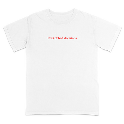 Front view of a white graphic T-shirt featuring the phrase "CEO of bad decisions" in small vintage-style red lettering centered on the chest. This minimalist humor tee offers a clean, trendy design that's perfect for casual everyday wear and sarcastic self-expression.