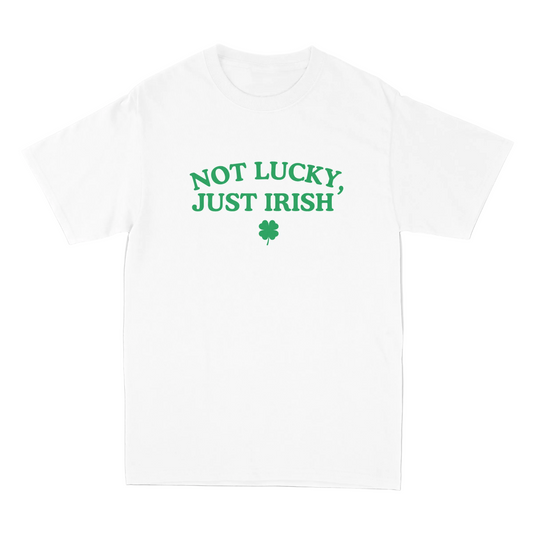 White t-shirt with 'Not Lucky, Just Irish' text and shamrock on a gray background