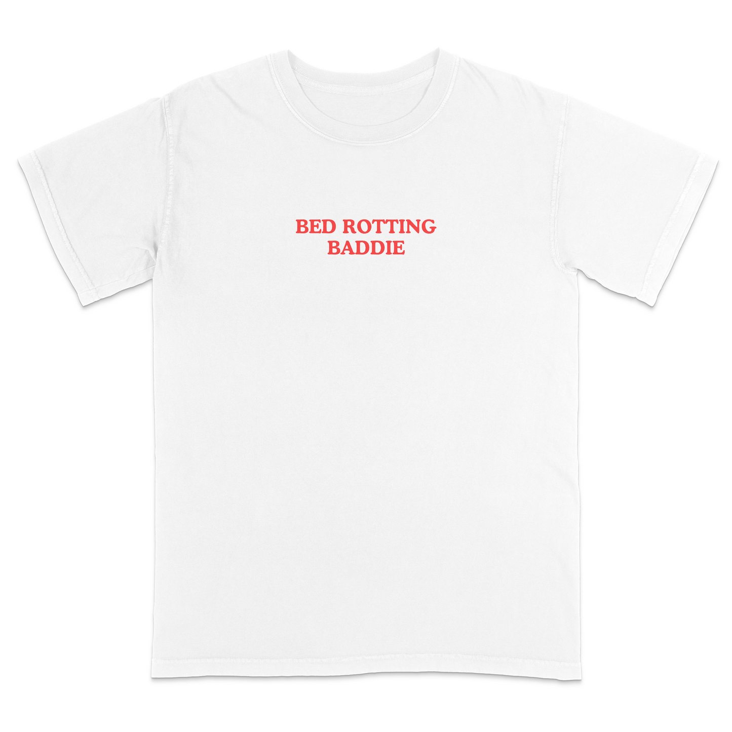 Front view of a white graphic T-shirt featuring the phrase "BED ROTTING BADDIE" in small vintage-style red lettering centered on the chest. This minimalist, trendy tee combines clean aesthetics with humorous Gen Z-inspired text for a casual everyday look.