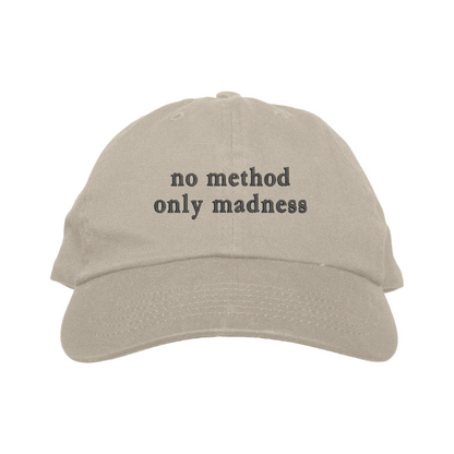 Beige cap with 'no method only madness' text on a white background